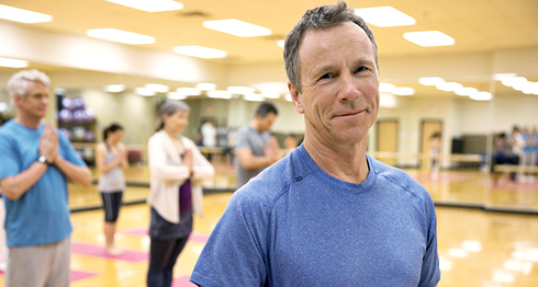 Older man in yoga class